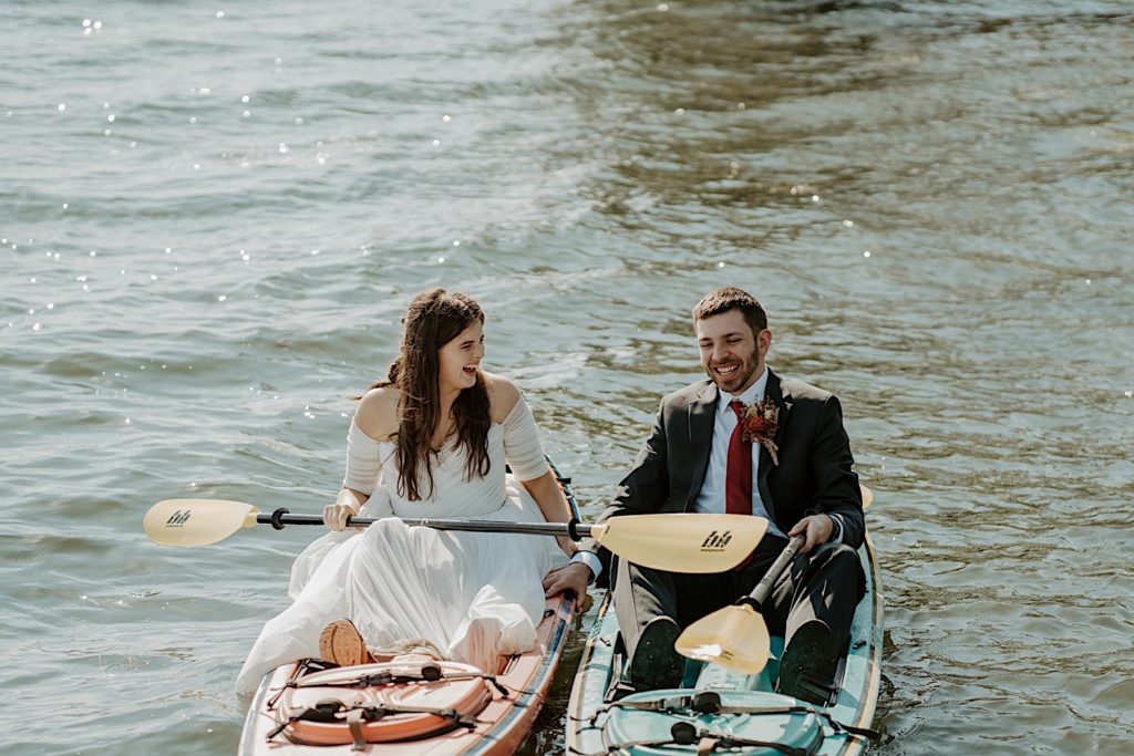 Bride and groom kayaking after their intimate elopement in the Finger Lakes NY