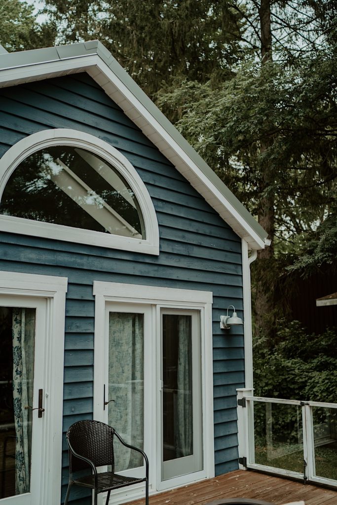 A blue and white house in a forest