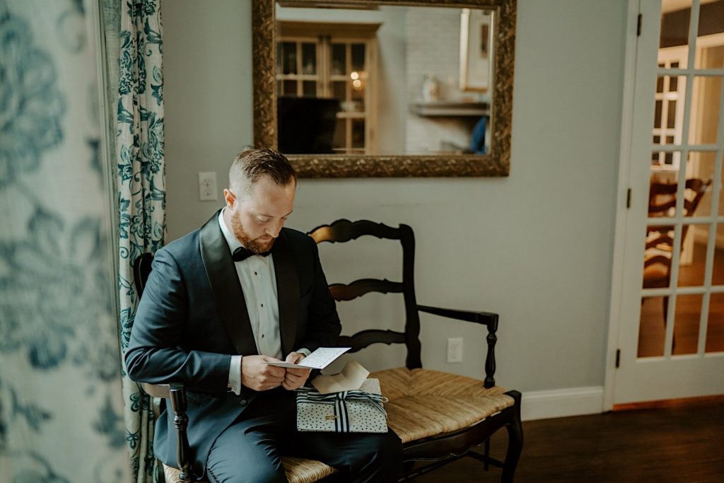 Groom sits and reads a letter from his bride to be before his wedding day