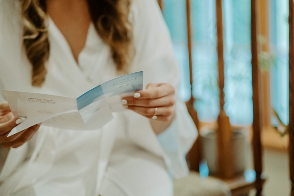 Close up of a bride's hands holding a letter