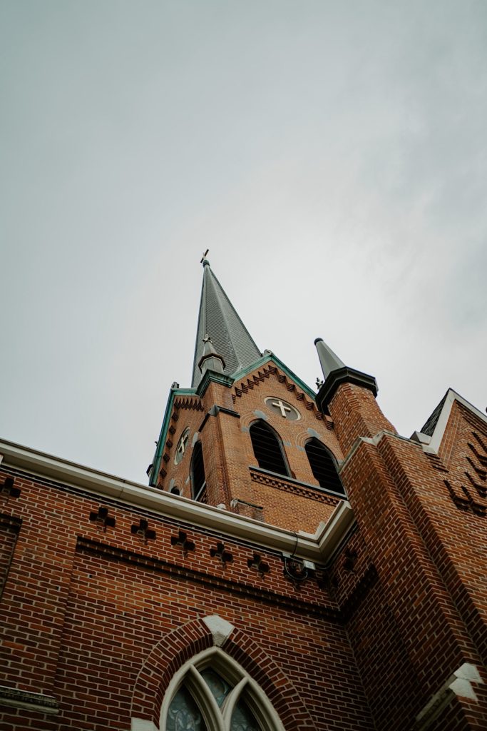 A roof of a catholic church going up towards the sky