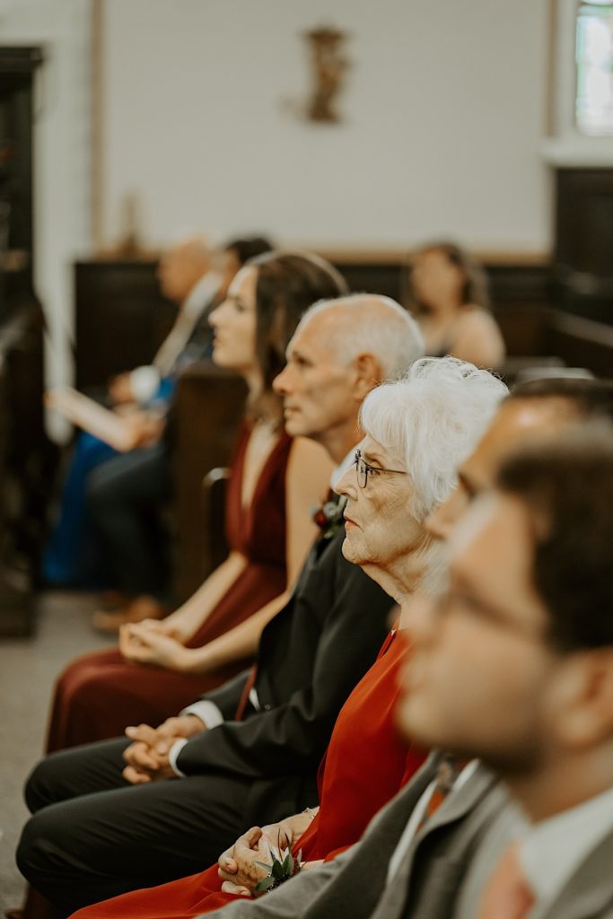 Family members watch wedding ceremony in a catholic church