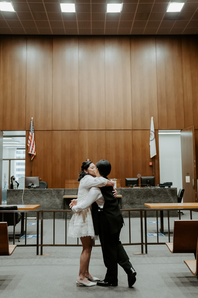 Two brides kiss and hold one another  after they are legally married at the Cook County Courthouse.