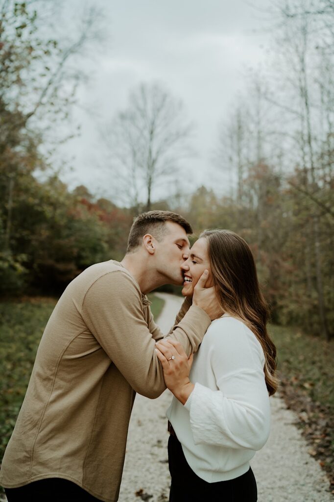 Fiancées hold each other tight and press their foreheads together in a Indiana Forest Preserve.