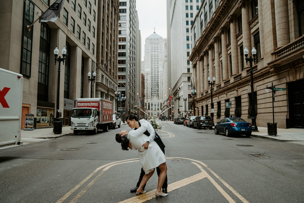 Newly weds dance in the middle of a street in Chicago sharing an intimate moment with one another in downtown Chicago after their elopement.