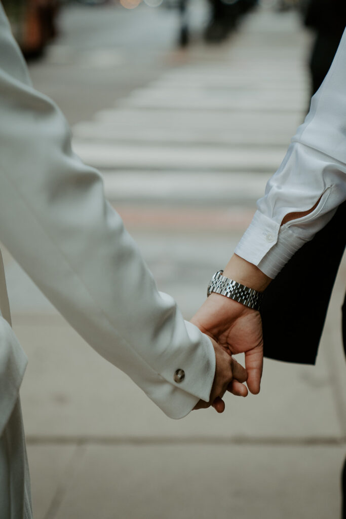 A close up of the newly weds hands holding eachother.