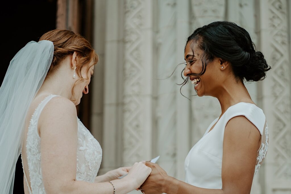 Brides giggle as they hold hands outside Scottish Rite Cathedral in Indianapolis. 