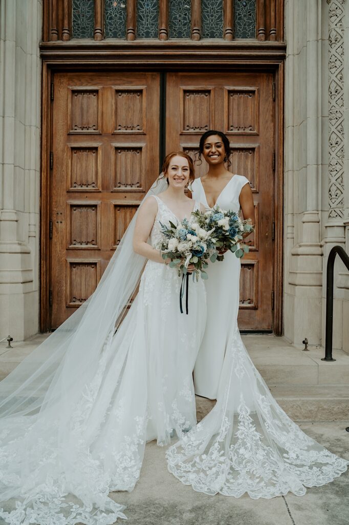 Brides pose in their diamond white dresses on the steps in front of the front door outside the Scottish Rite Cathedral in Indianapolis. 