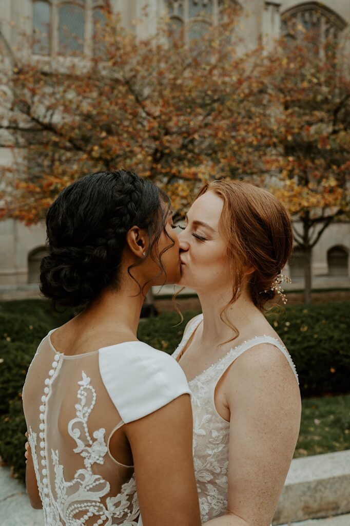 Brides kiss outside the Scottish Rite Cathedral in Indianapolis. 