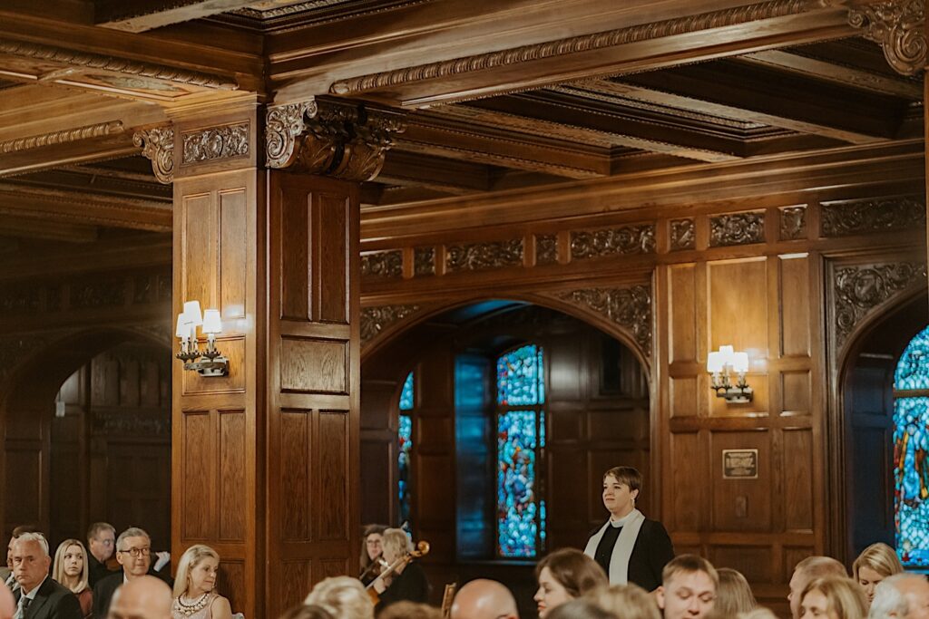 Indianapolis Wedding Photographer captures the details of the Scottish Rite Cathedral's wooden oak walls with lamps and ornate carvings. 