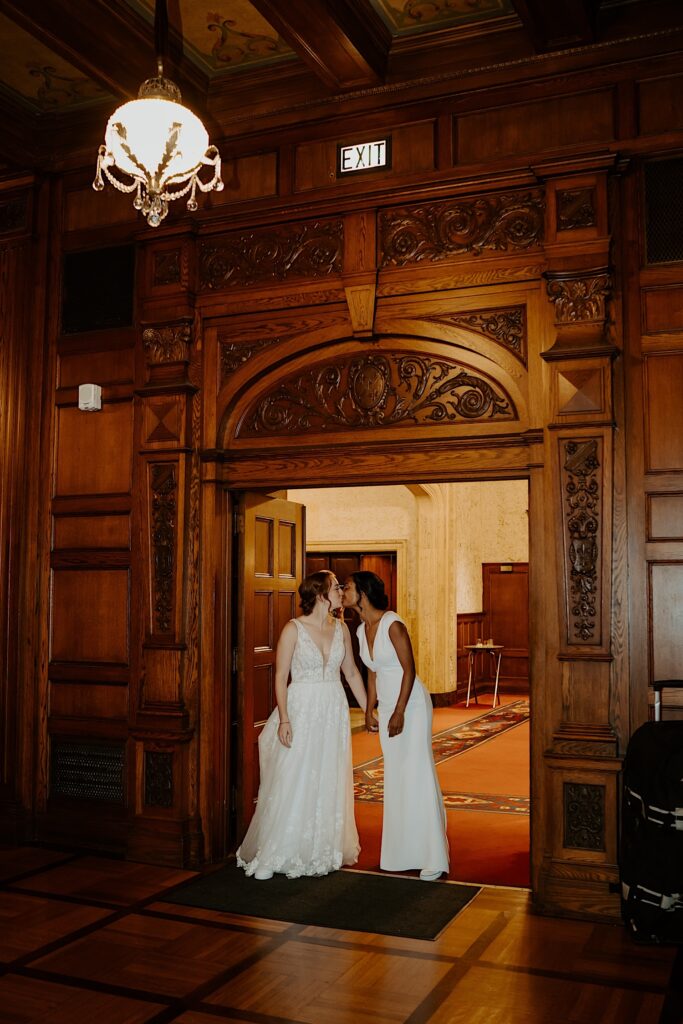 Bride's kiss as they enter the 1920's style reception room at Scottish Rite Cathedral in Indianapolis. 