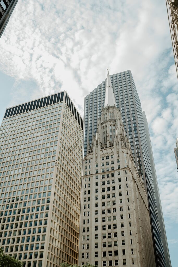 Midwest Elopement Photographer captures Chicago skyscrapers towering in the sky with clouds in the background. 