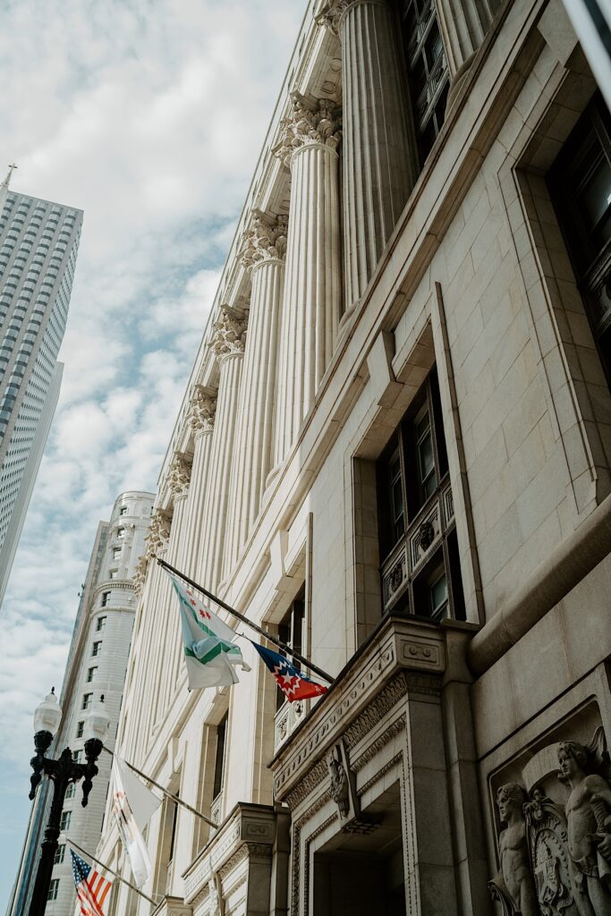 Midwest Elopement Photographer captures Chicago City Hall with clouds in the sky. 