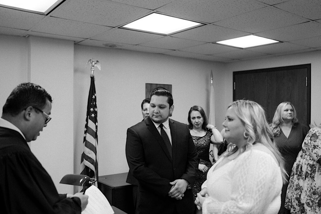 Bride and Groom look at the judge during their elopement ceremony in Chicago City Hall. 