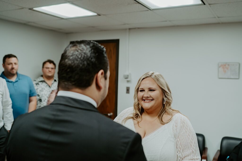 Bride smiles at the Groom during elopement ceremony at Chicago City Hall. 