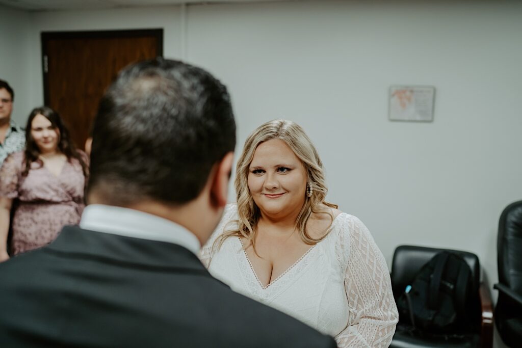 Bride smiles emotionally at Groom during elopement ceremony in Chicago City Hall. 