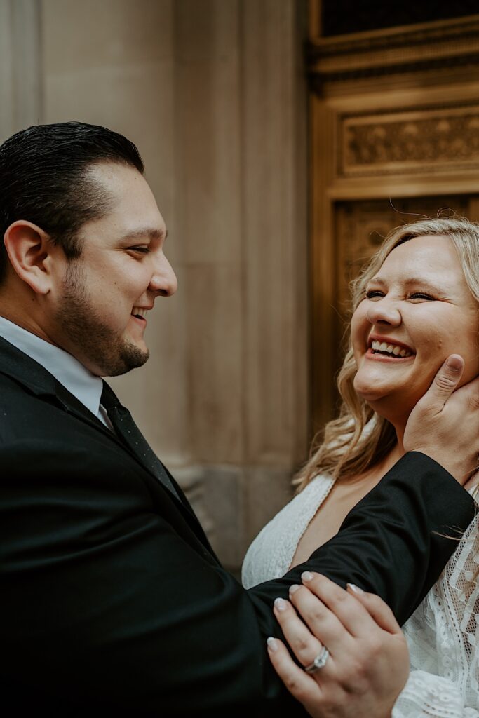 Bride and Groom laugh candidly during elopement portraits in Chicago. 