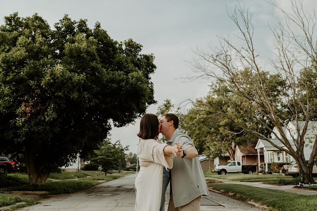 Couple dances and kisses in the center of the street in their neighborhood in Lafayette, Indiana. 