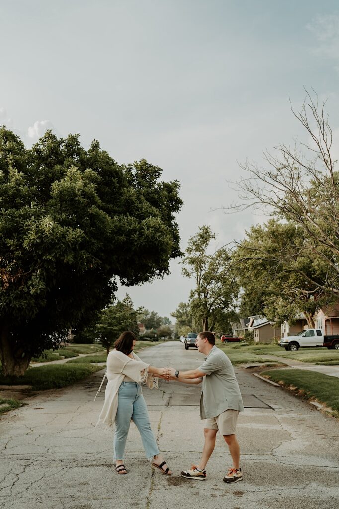 Couple dances and kisses in the center of the street in their neighborhood in Lafayette, Indiana. 