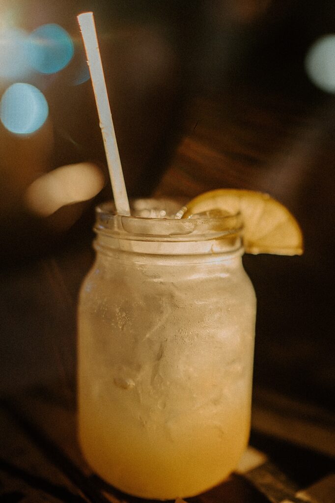 Margarita sits on a wooden table. 