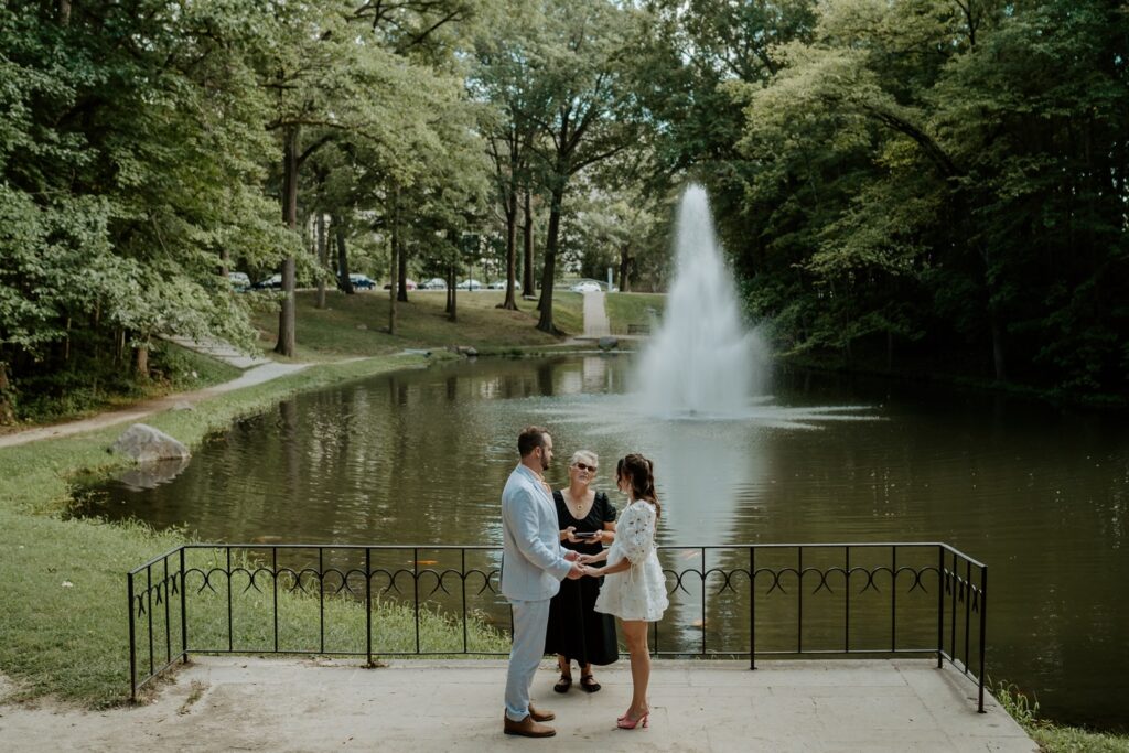 A bride and groom elope with a witness at Holcomb Gardens in Indianapolis.