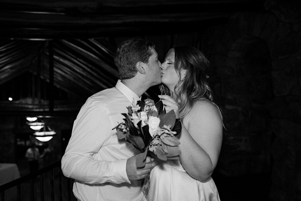 A bride and groom kiss during their wedding reception at Mt Woodson Castle.