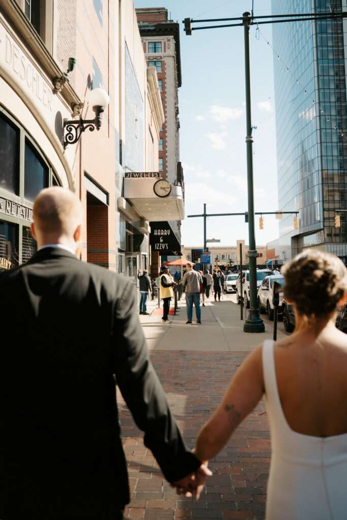 couple walking towards harry and izzys reception