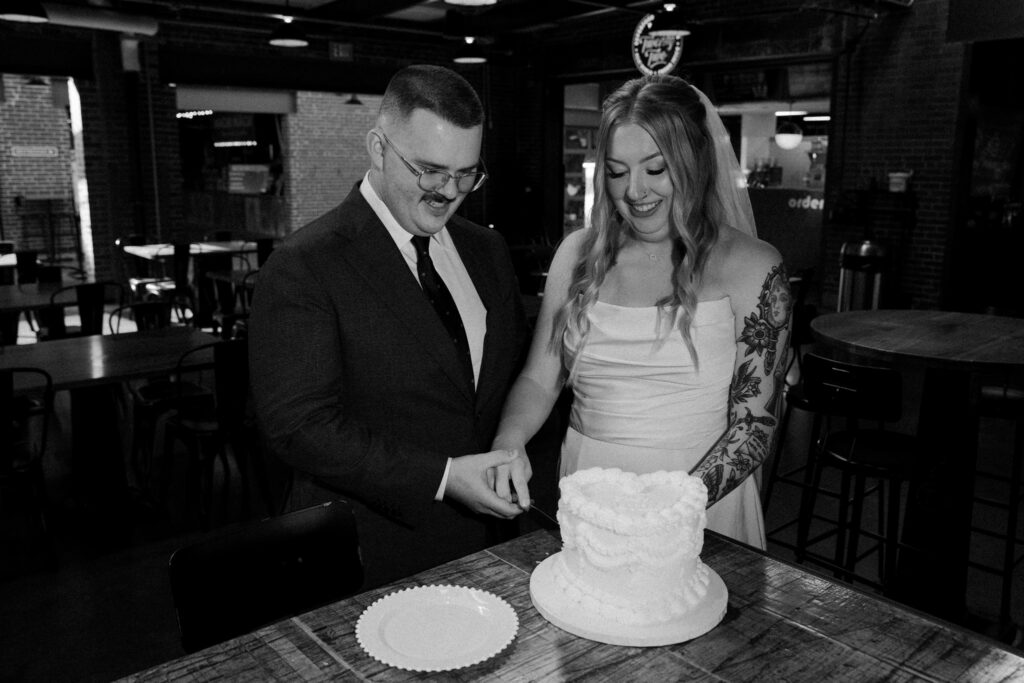 black and white photo of a couple eating cake