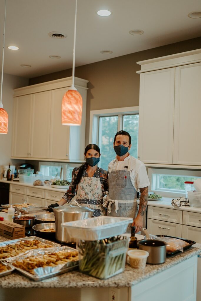 two chefs looking over the food they cooked