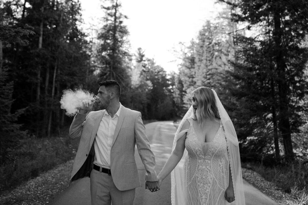 couple looking towards the woods while smoking a cigar