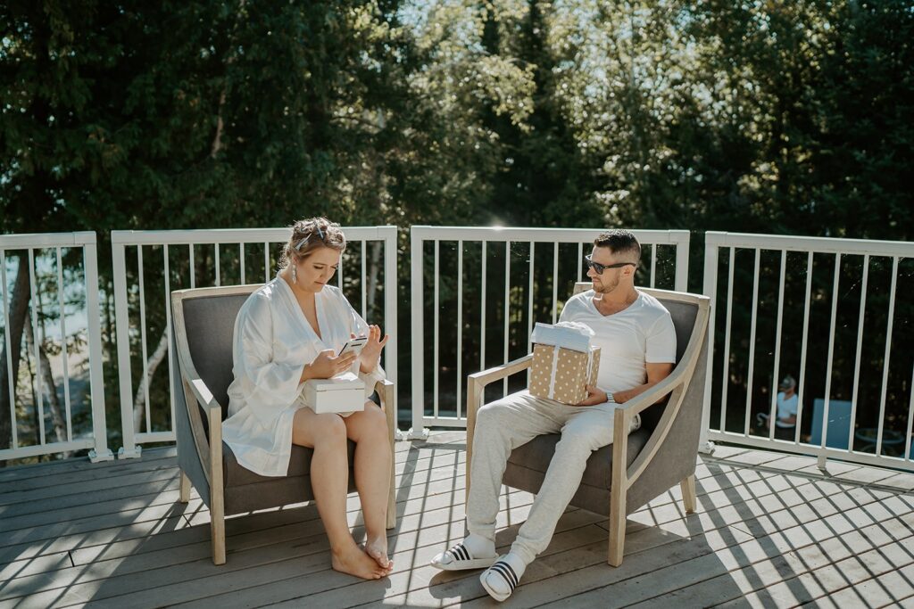 couple sitting together and reading through their gifts