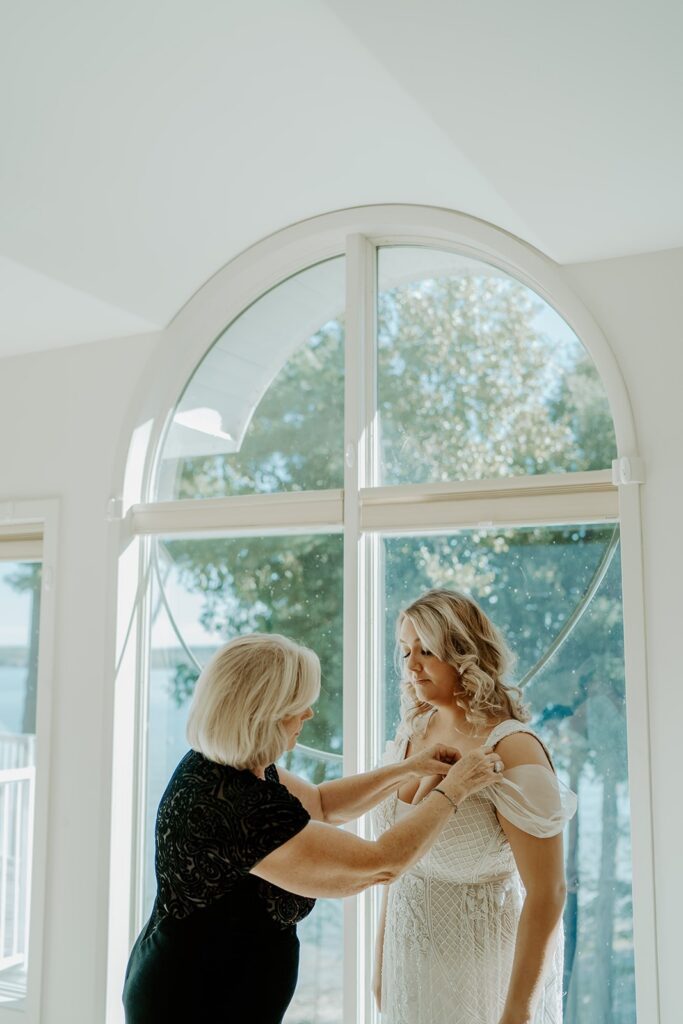 bride getting ready with mother of the bride