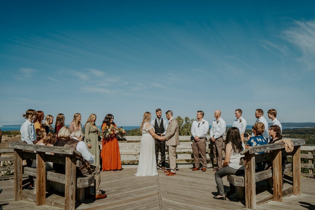 couple and family during wedding ceremony on boardwalk