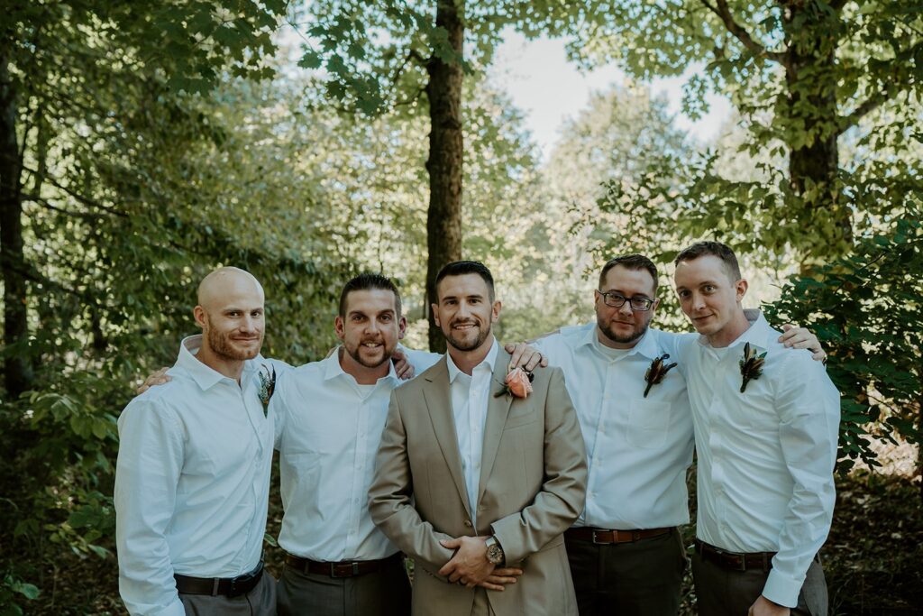 groomsmen looking at camera in the woods